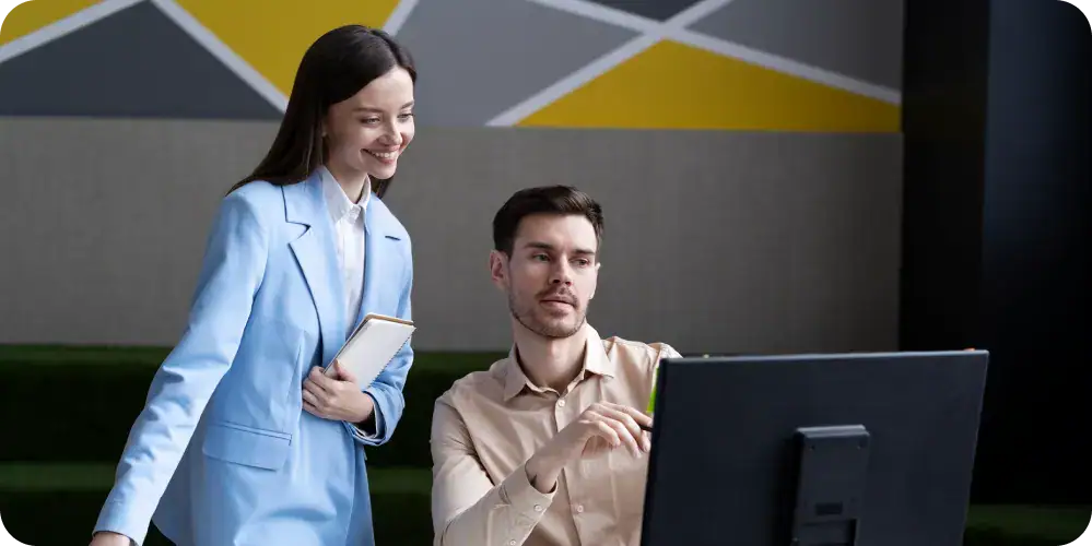 Business Intelligence Team Collaboration | i3solutions Business professionals analyzing data on a computer screen.