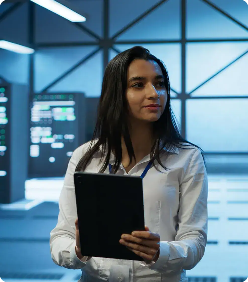 Enterprise IT Solutions by i3solutions | i3solutions Businesswoman holding tablet in modern office environment.