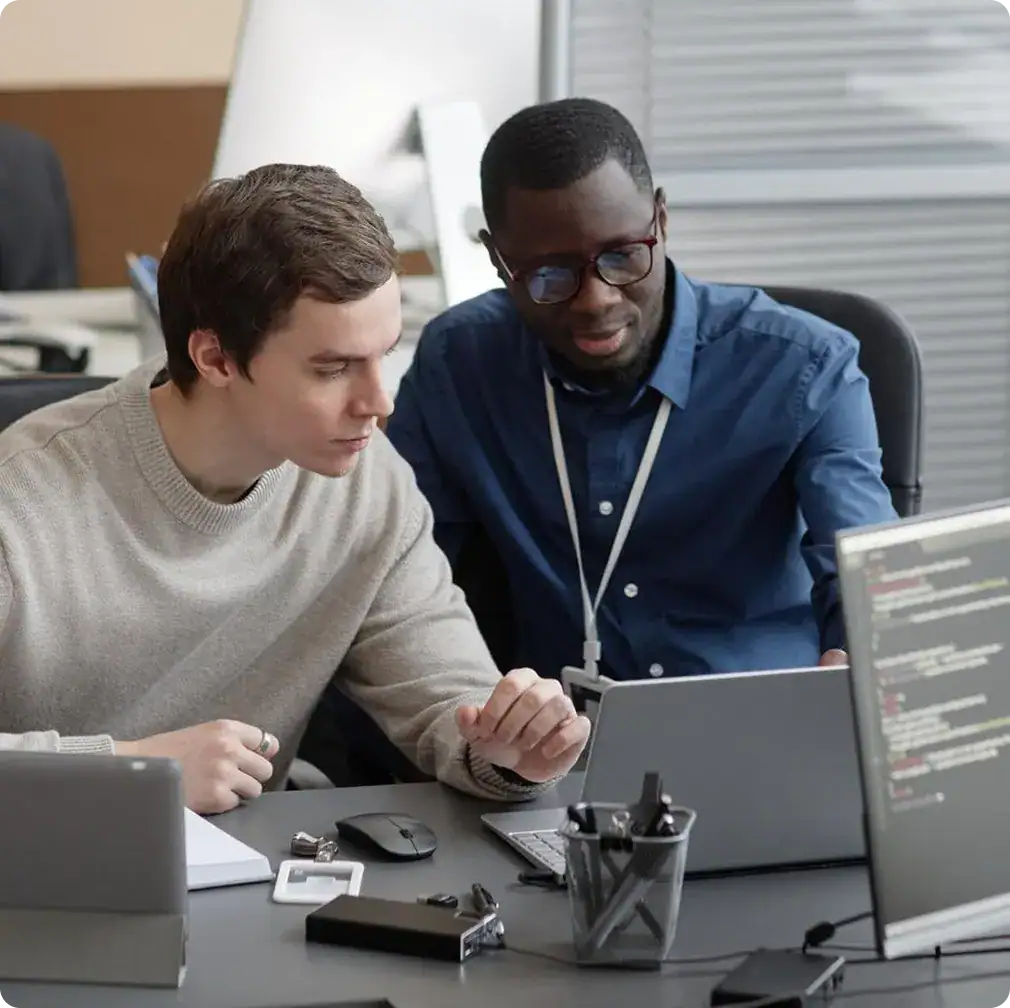 Two professionals working together on workflow automation project.