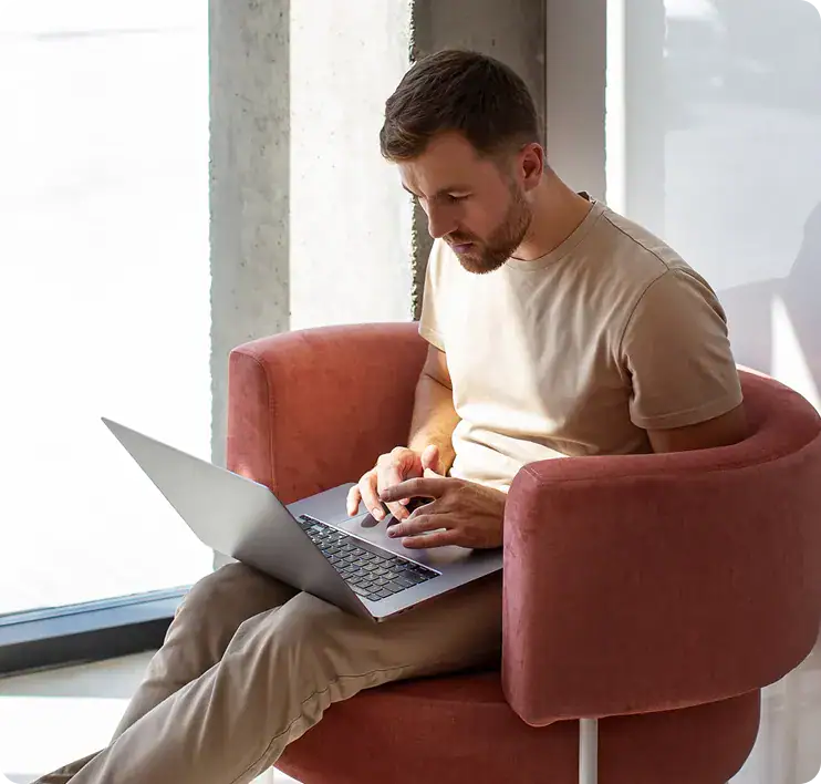 Man Using Laptop for Augmented Analytics | i3solutions Man working on laptop for augmented analytics services.