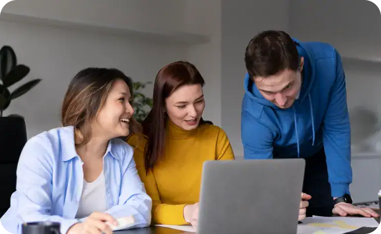 Team of developers collaborating on a project with a laptop.