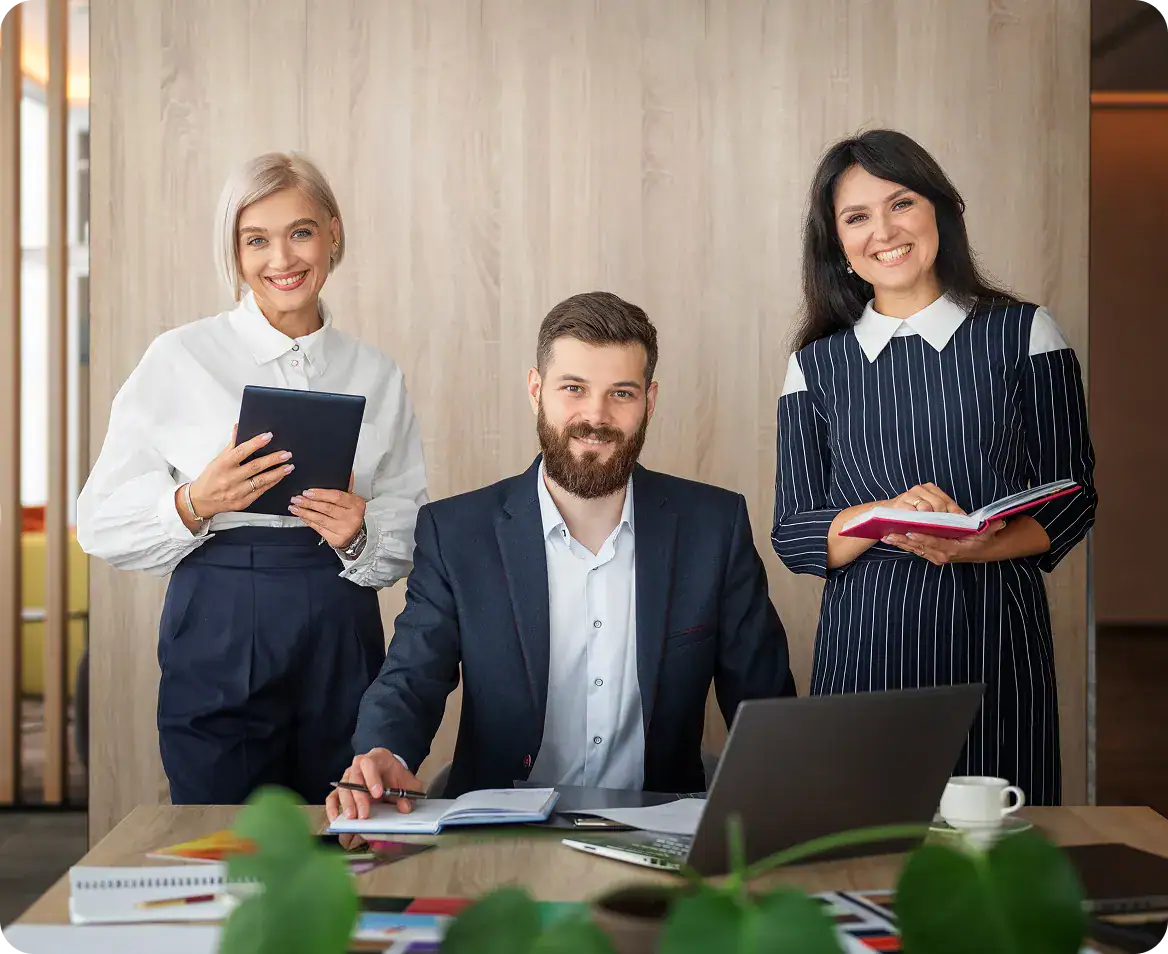 Business team meeting with three professionals in office setting.