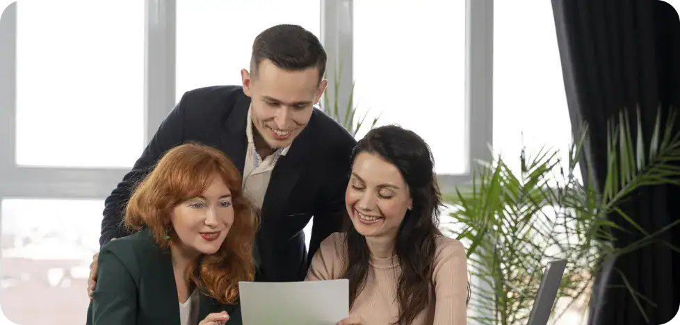 Business team discussing project details in a modern office setting.