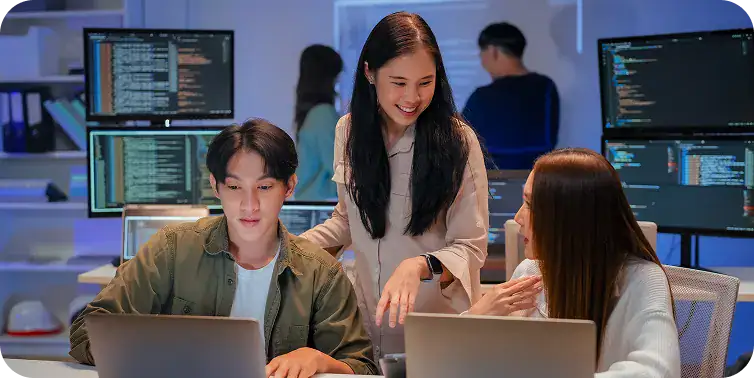 Team working together on coding and software development in a modern office.
