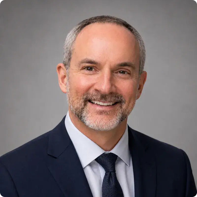 Professional Business Leader Portrait Smiling mature businessman in formal suit and tie.