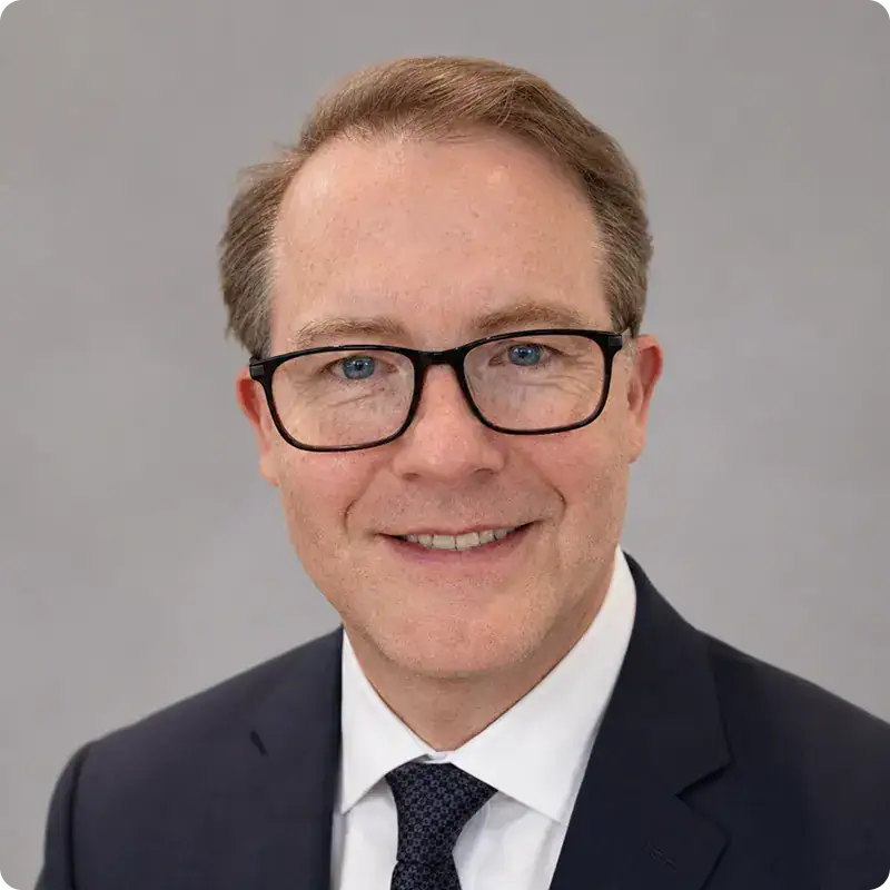 Professional Business Leader Portrait Business leader wearing glasses in formal suit for leadership theme.