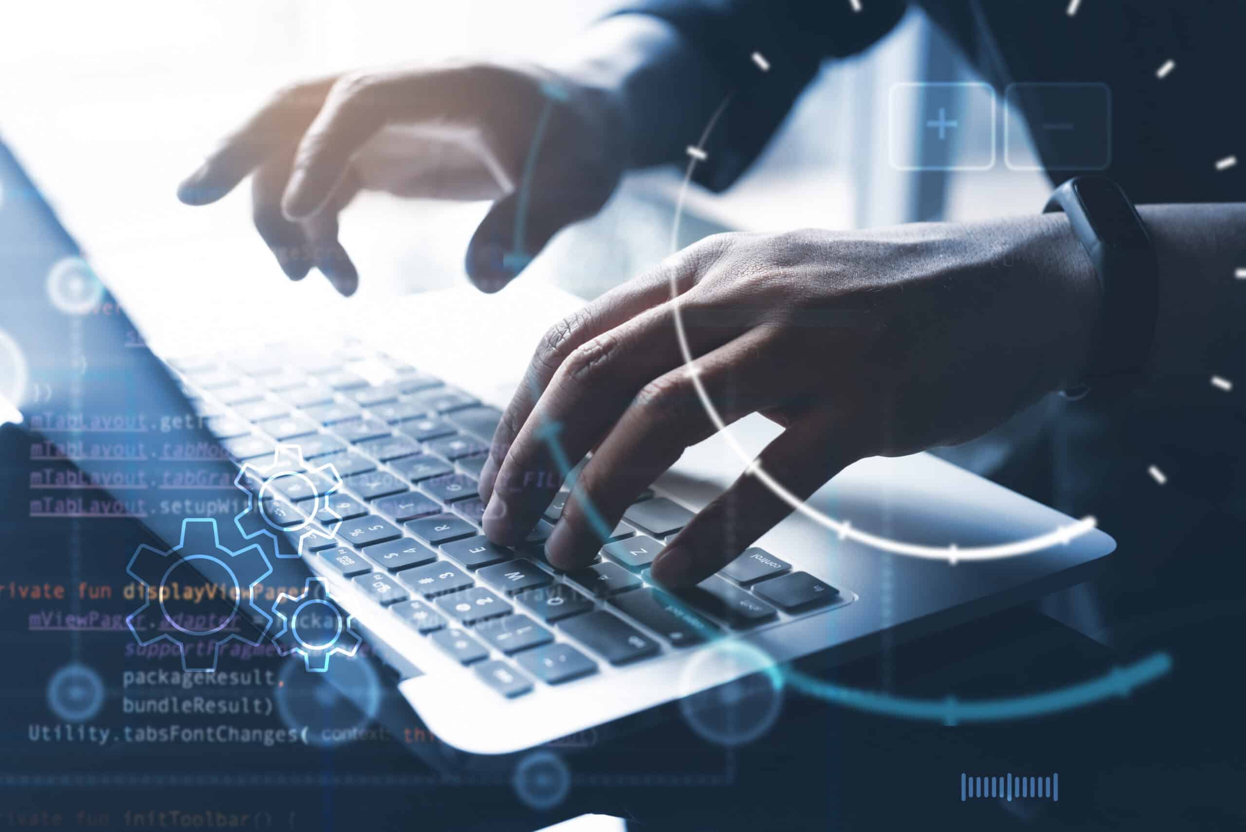 Person typing on a laptop with digital overlay and data graphics.