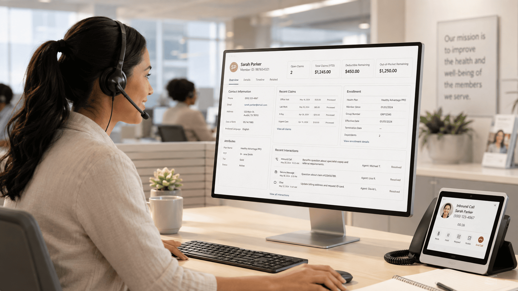 Customer support agent using computer and tablet at modern office.