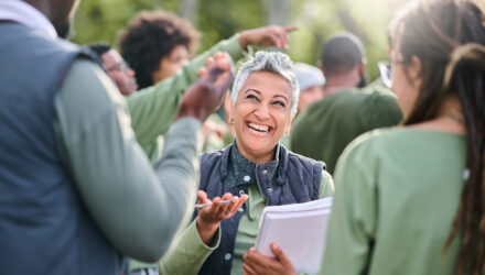 Diverse Group of People Outdoors Engaging | i3solutions Diverse group of people outdoors engaging in a lively discussion.