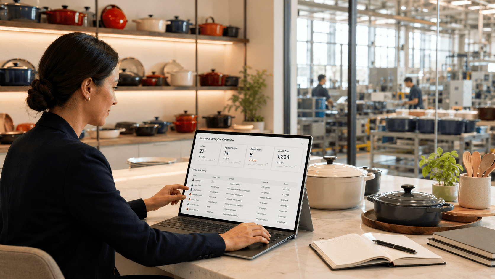 Businesswoman analyzing data on a laptop in a modern kitchen showroom.