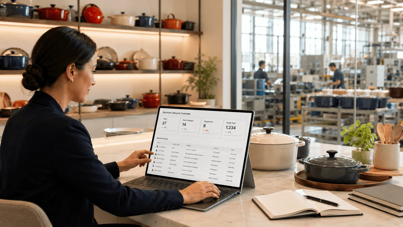Businesswoman analyzing data on a laptop in a modern kitchen showroom.