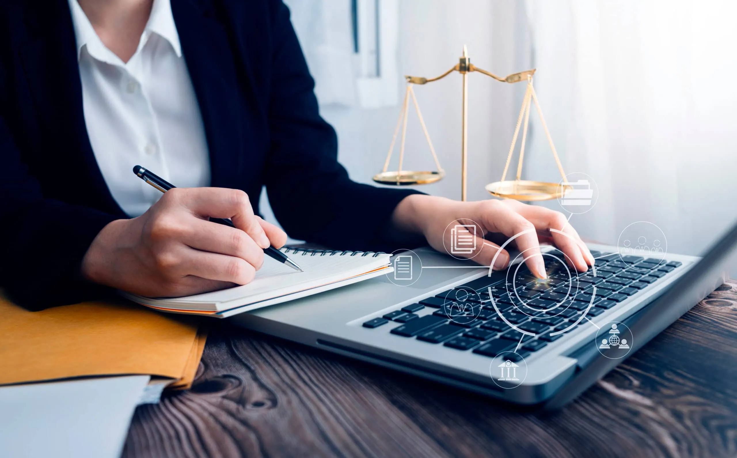 Businesswoman Using Laptop with Digital Legal | i3solutions Businesswoman using laptop with digital legal and justice icons overlay.