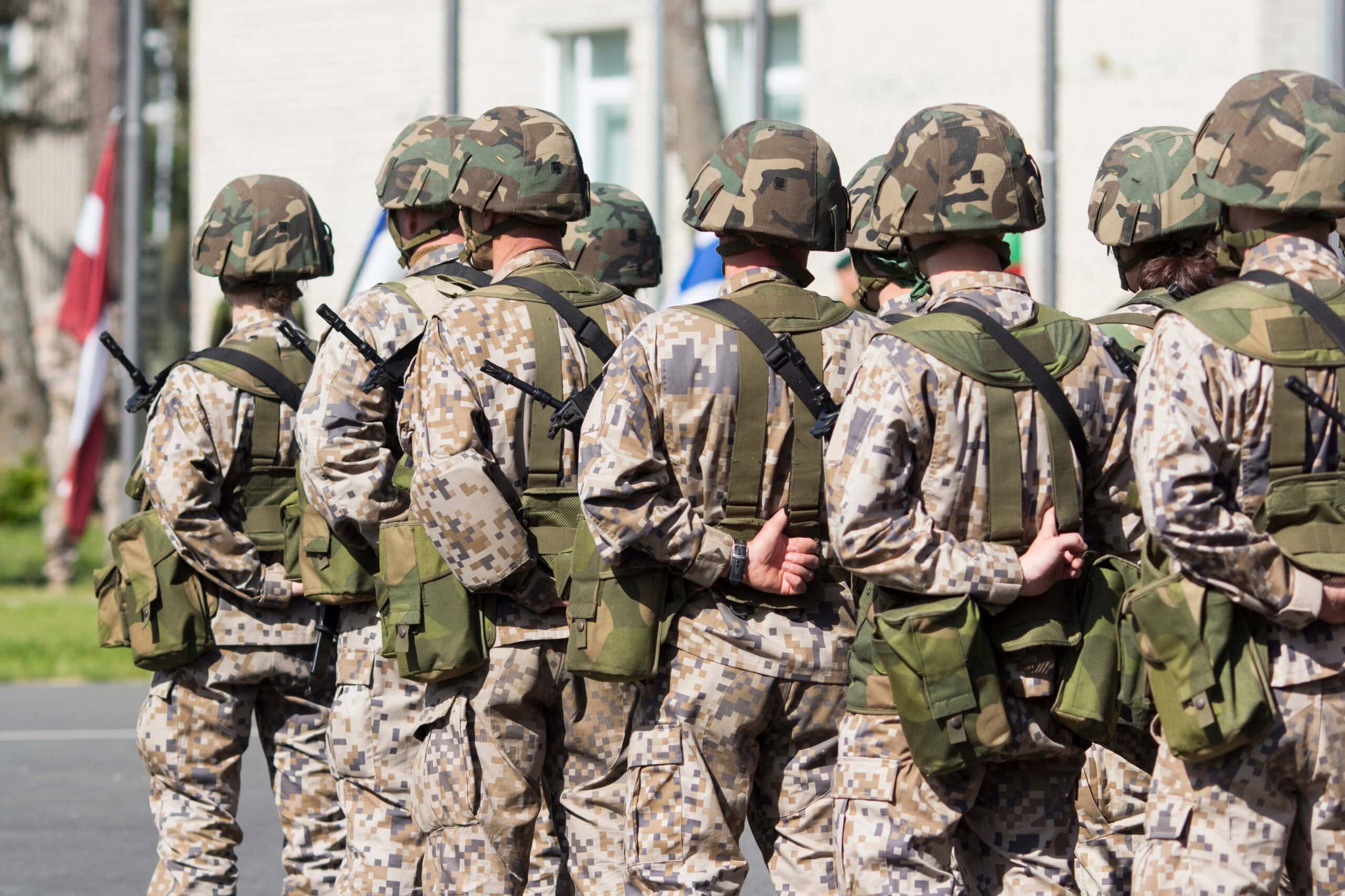 Military Soldiers in Camouflage Uniforms Standing | i3solutions Military soldiers in camouflage uniforms standing in formation outdoors.