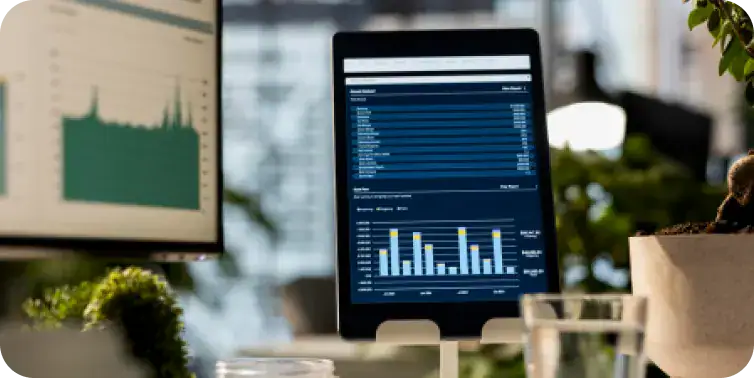 Business Data Analytics on Tablet Tablet displaying business analytics and financial charts in an office setting.